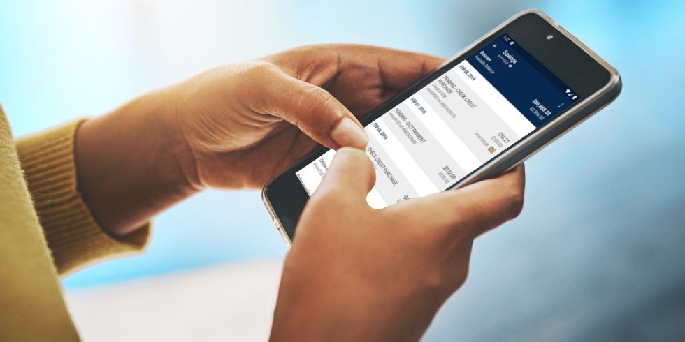 Cropped shot of a businesswoman using a mobile phone in an office